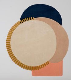 three circular rugs with different colors and shapes