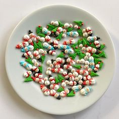 a white plate topped with lots of small toy figurines