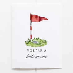 a card with an image of a red flag and the words you're a hole in one