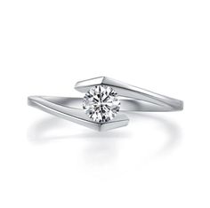 a white gold ring with a single diamond in the center and two curved shans on each side