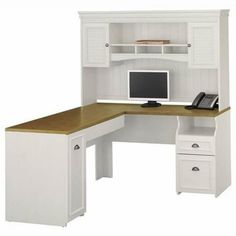 a desk with a computer on top of it and drawers underneath the desk is white