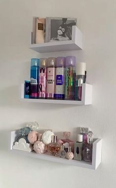 two white shelves filled with different types of cosmetics