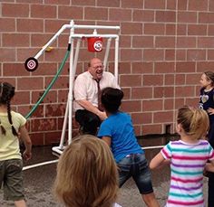 a group of children and an older man playing frisbee