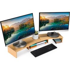 two computer monitors sitting next to each other on top of a wooden desk with a keyboard and mouse