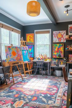 an artist's studio with easels, paintings and other art on the walls