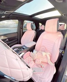 the interior of a car with pink leather seats and bows on the front row seat