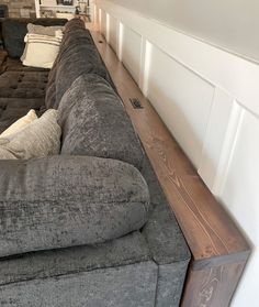 a long couch sitting in the corner of a living room