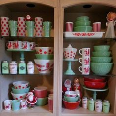 two shelves filled with dishes and cups on top of each other