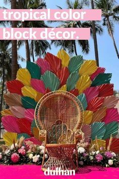 a chair that is sitting in front of some flowers and umbrellas with the words tropical color block decor on it