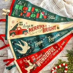 three christmas pennants with holiday sayings on them