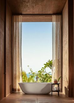 a bath tub sitting in front of a window