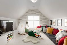 a living room filled with furniture and a flat screen tv