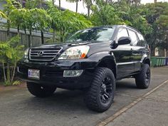 a black suv is parked on the street