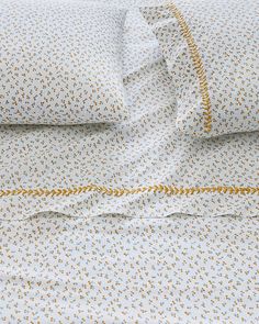 the bedding is made up with blue and yellow flowers