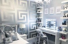 a bedroom with gray walls and white furniture