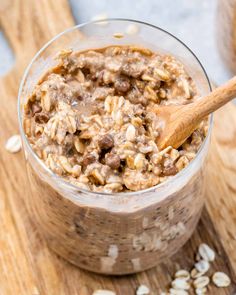 an oatmeal in a glass bowl with a wooden spoon