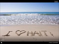 the word i love hawaii written in sand at the beach