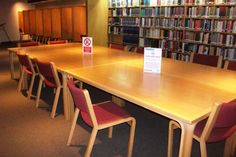 a long table with chairs around it in a library