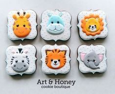 four cookies decorated with animals and giraffes