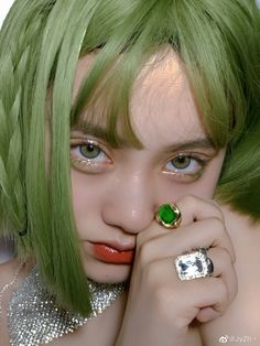 a woman with green hair wearing a ring