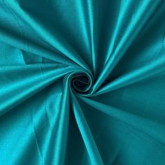 a close up shot of a teal colored fabric