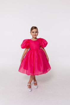 Stylish and stunning full skirt dress for a little princess in a splendid fuchsia colour decorated with the cutest black bow. The dress has an open back and trendy puffy half sleeves.  This kids dress will work well for any special occasion: birthday, kids party, wedding, communion, baptism, any other event.  The lining is 100% cotton for safety and comfortable fit. *Please note that colors may slightly vary depending on your monitor settings. Bright pink girl dress, fuchsia kids dress, organza girl dress with sleeves, kids bridesmaid dress, special occasion dress for girls You can find more gorgeous girl dresses in my Sweet Princess Dress shop by following this link: https://www.etsy.com/shop/SweetPrincessDress The dress is made from high-quality fabrics. Please ensure you send measuremen Pink Frocks For Kids, Short Sleeve Organza Dress With Fitted Bodice, Pink Princess Tulle Bridesmaid Dress, Pink Princess Bridesmaid Dress In Tulle, Pink Tulle Princess Bridesmaid Dress, Princess Style Organza Pageant Dress, Fitted Organza Dress For Pageants, Pink Princess Organza Gown, Fitted Organza Princess Dress For Pageants