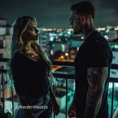 a man standing next to a woman on top of a balcony