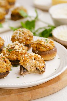 small appetizers are on a white plate next to other food items and utensils