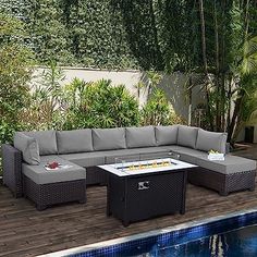 an outdoor patio furniture set next to a swimming pool