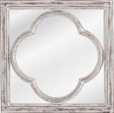 a white mirror with an ornate design on it