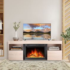 a flat screen tv sitting on top of a wooden entertainment center next to a fire place