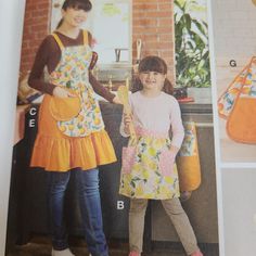 two girls in aprons standing next to each other