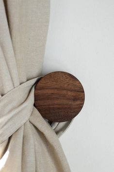 a curtain with a wooden button on it