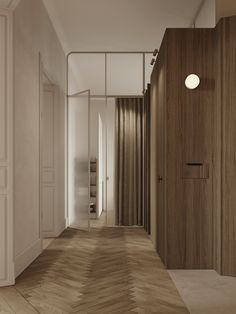 an empty hallway with wood paneling and white walls