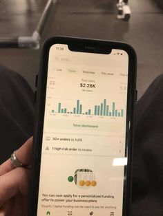 someone is holding up their iphone with the screen showing an average amount of data on it