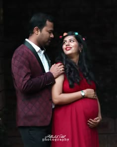 a pregnant couple standing next to each other