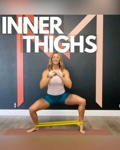 a woman is doing squats in front of a wall with the words inner thighs on it