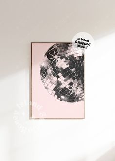 a pink and black poster hanging on the wall