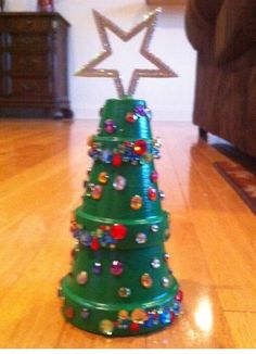 a small green christmas tree on the floor