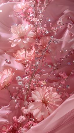 pink flowers are in the middle of a bed with satin material on it and beading around them