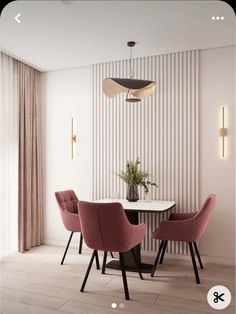 a dining room with pink chairs and a white table in front of a striped wall