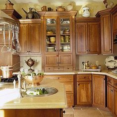 a kitchen filled with lots of wooden cabinets