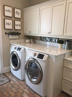 a washer and dryer in a laundry room with pictures on the wall above them