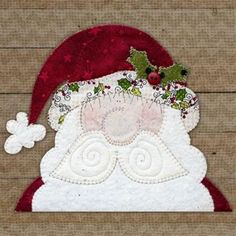 a close up of a santa claus hat on a wooden surface with a white snowflake