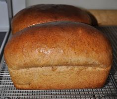 two loaves of bread cooling on a rack