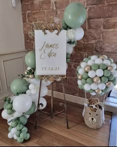 balloons and signs are on display in front of a brick wall