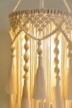 a white chandelier with tassels hanging from it