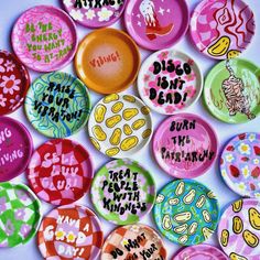 many different colored buttons with words on them