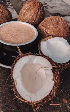 some coconuts are sitting on the ground next to a cup of hot cocoa drink