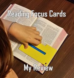 a woman reading a book with the words reading focus cards my review written on it